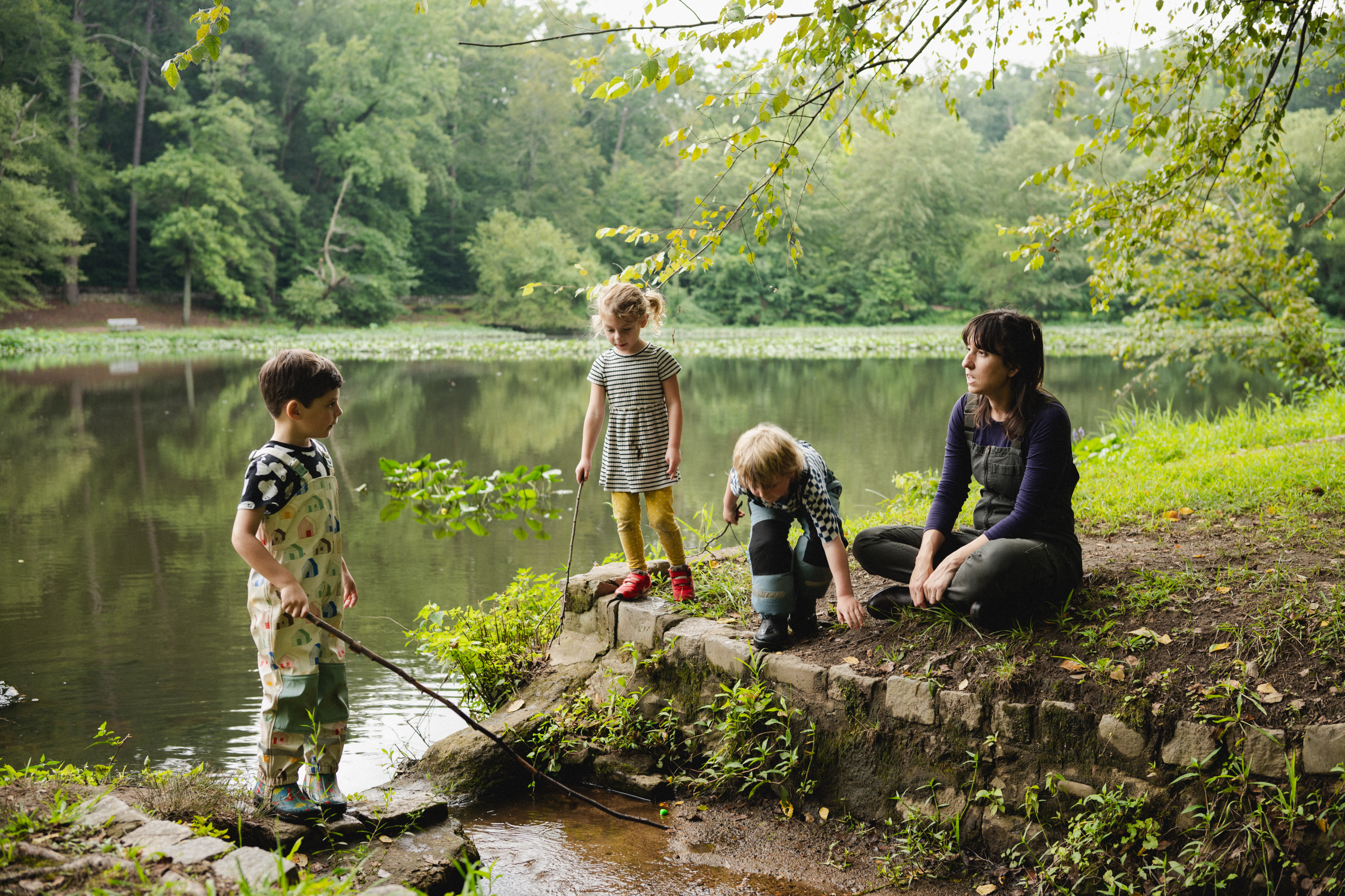 teacher and three chidlren at waters edge
